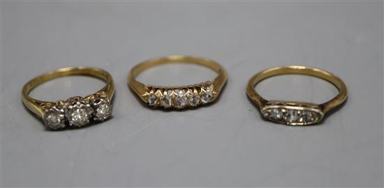 Three assorted early 20th century and later 18ct and diamond set rings, including five stone and illusion set.